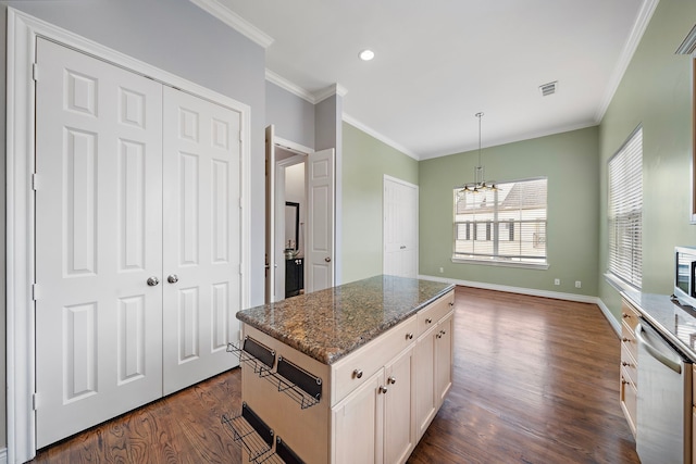 kitchen with a kitchen island, dark hardwood / wood-style floors, dishwasher, dark stone counters, and hanging light fixtures