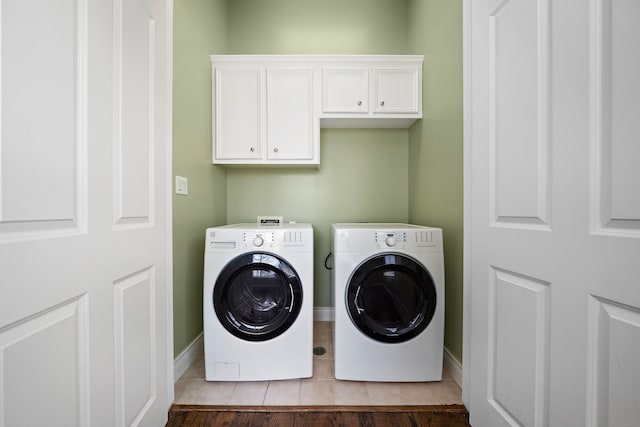 laundry room with cabinets and washing machine and dryer