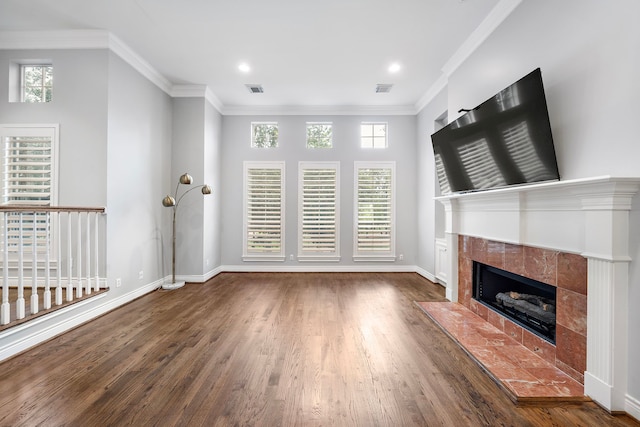 unfurnished living room featuring ornamental molding, dark wood-type flooring, and a fireplace