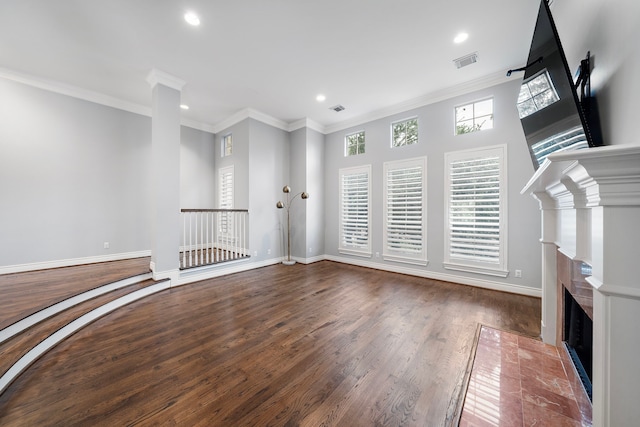 unfurnished living room featuring hardwood / wood-style flooring and ornamental molding