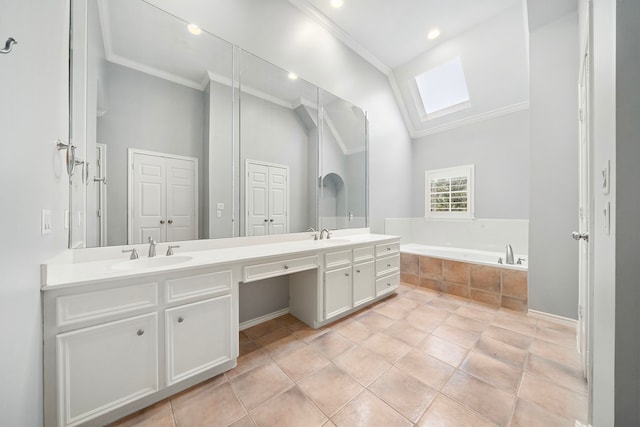 bathroom featuring lofted ceiling with skylight, ornamental molding, vanity, a relaxing tiled tub, and tile patterned flooring