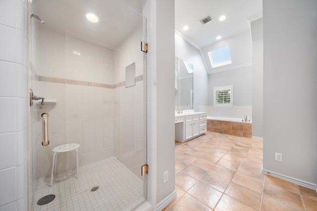 bathroom with tile patterned floors, crown molding, a skylight, separate shower and tub, and vanity