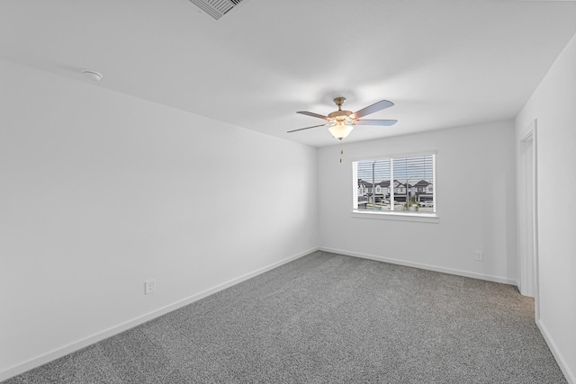 carpeted spare room with ceiling fan