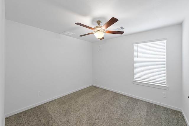 empty room with ceiling fan and carpet