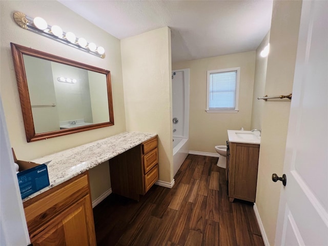 full bathroom with vanity, hardwood / wood-style flooring, toilet, and shower / bath combination