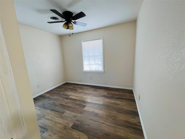 empty room with dark hardwood / wood-style floors and ceiling fan