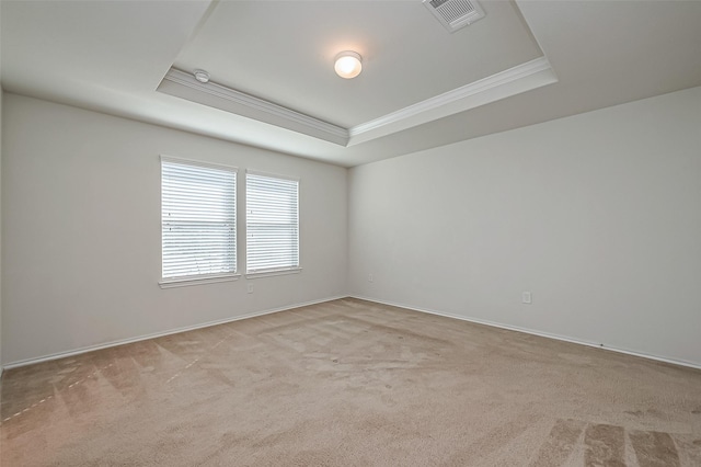 unfurnished room featuring visible vents, crown molding, baseboards, carpet, and a raised ceiling