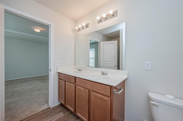 bathroom with vanity, hardwood / wood-style floors, and toilet