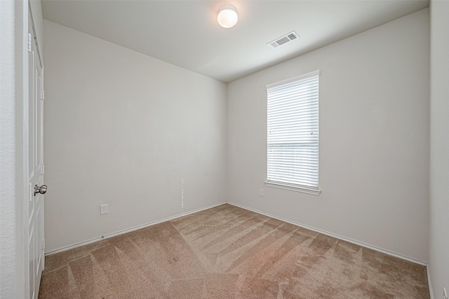 unfurnished room featuring light colored carpet