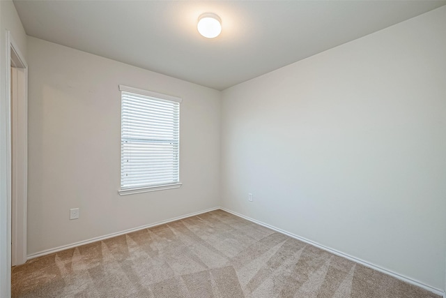 unfurnished room with light carpet