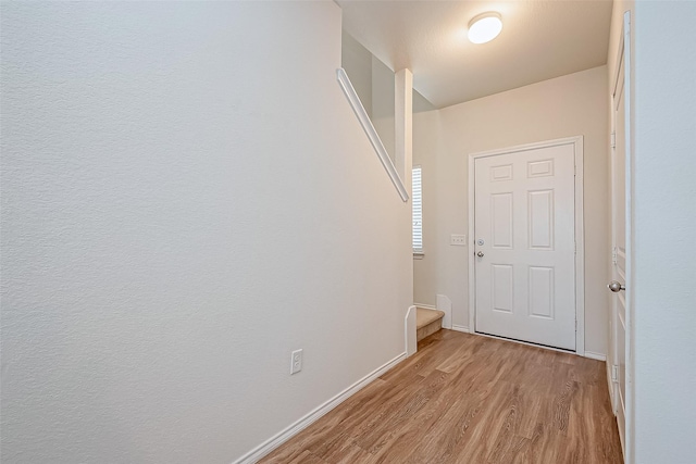 hallway with light hardwood / wood-style flooring