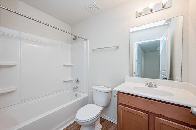 full bathroom featuring hardwood / wood-style flooring, vanity, bathing tub / shower combination, and toilet