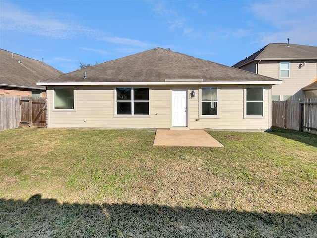 rear view of house with a patio and a lawn