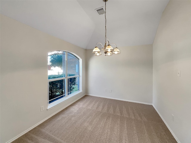 empty room featuring vaulted ceiling, carpet, and a chandelier