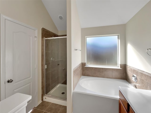 bathroom with lofted ceiling, separate shower and tub, tile patterned flooring, and vanity