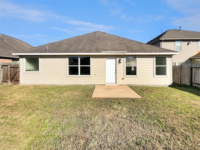 back of house with a patio and a lawn