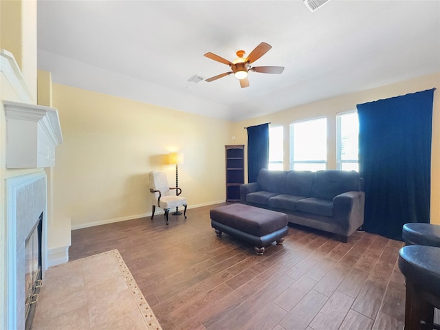 living room with dark wood-type flooring and ceiling fan