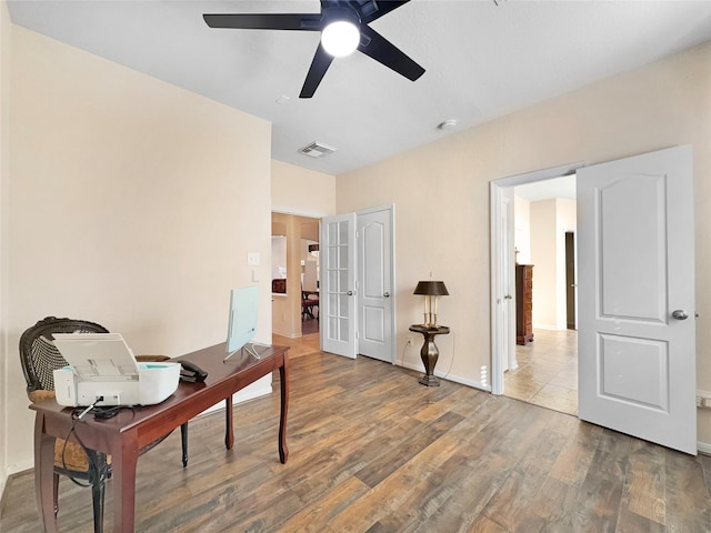 office space with french doors, ceiling fan, and wood-type flooring