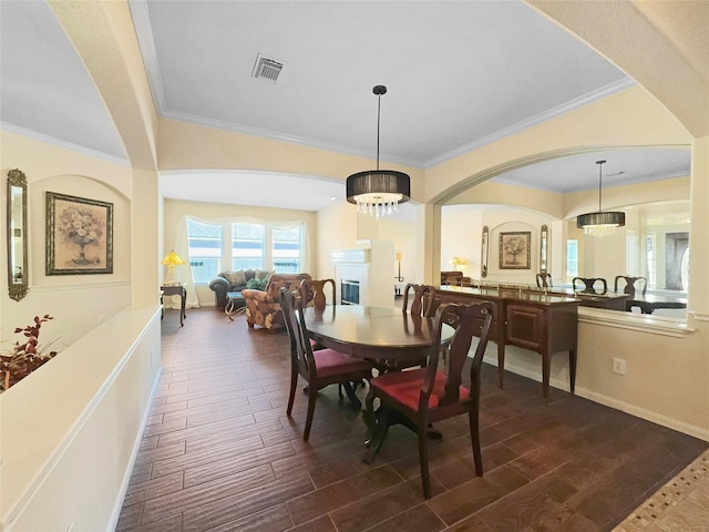 dining space featuring crown molding and a notable chandelier