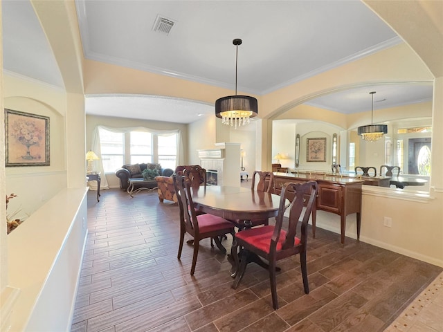 dining room featuring crown molding and a chandelier