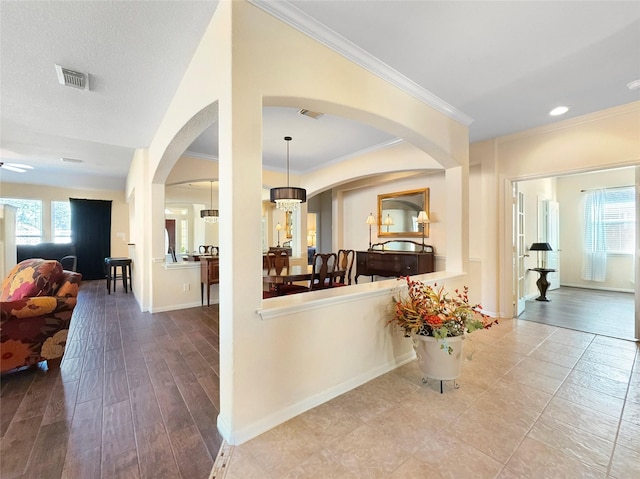 interior space featuring ornamental molding and light hardwood / wood-style floors