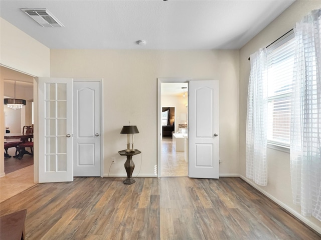 empty room with dark hardwood / wood-style flooring and french doors