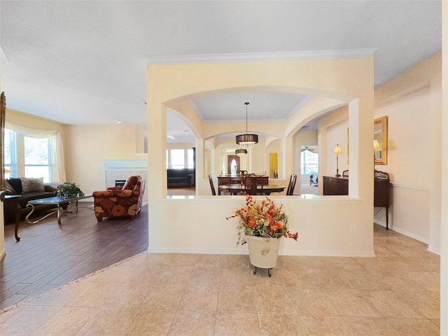 entrance foyer featuring crown molding and light tile patterned flooring