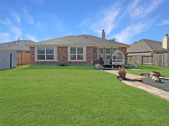 back of property with a lawn and a patio area