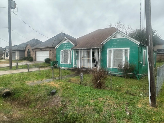 view of front of property featuring a garage and a front lawn