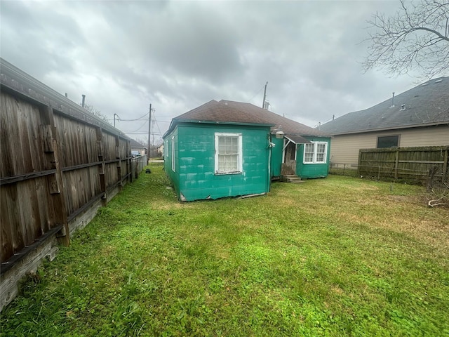 back of property featuring a lawn