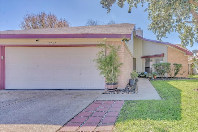 ranch-style home with a garage and a front lawn