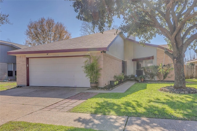 ranch-style house featuring a garage and a front lawn