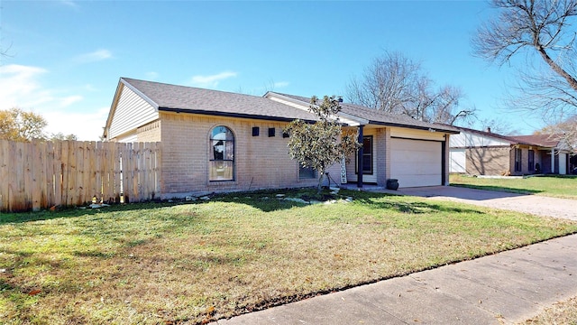 ranch-style home featuring a garage and a front yard