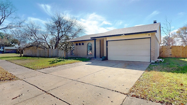 single story home with a garage and a front yard