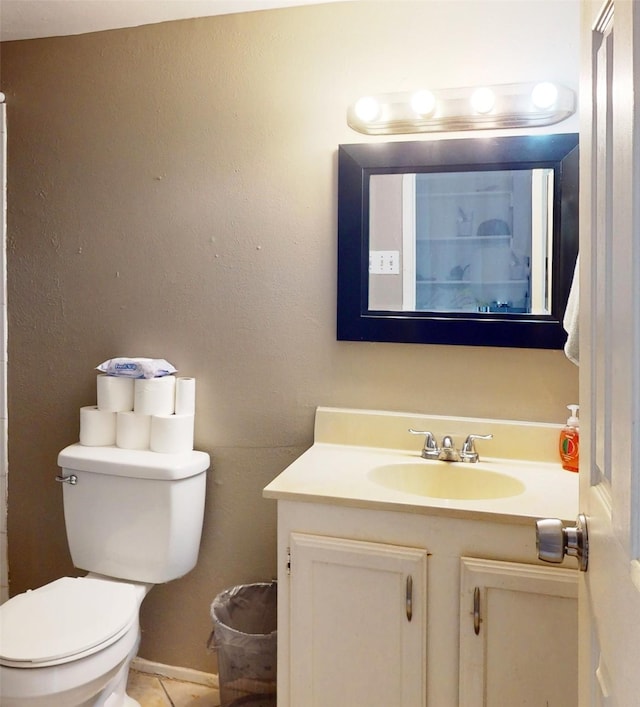 bathroom featuring vanity, toilet, and tile patterned flooring