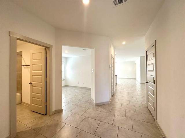 hallway featuring light tile patterned floors