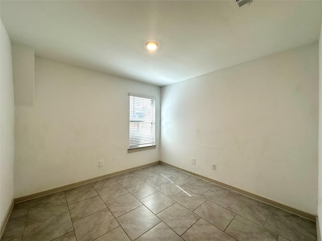 spare room featuring light tile patterned floors