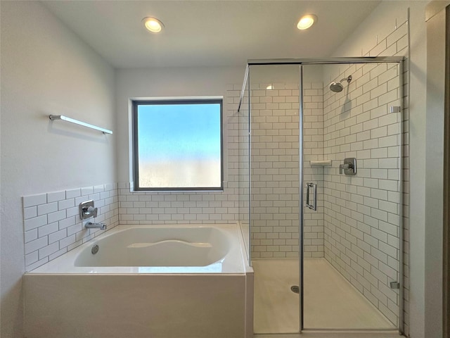 bathroom with separate shower and tub