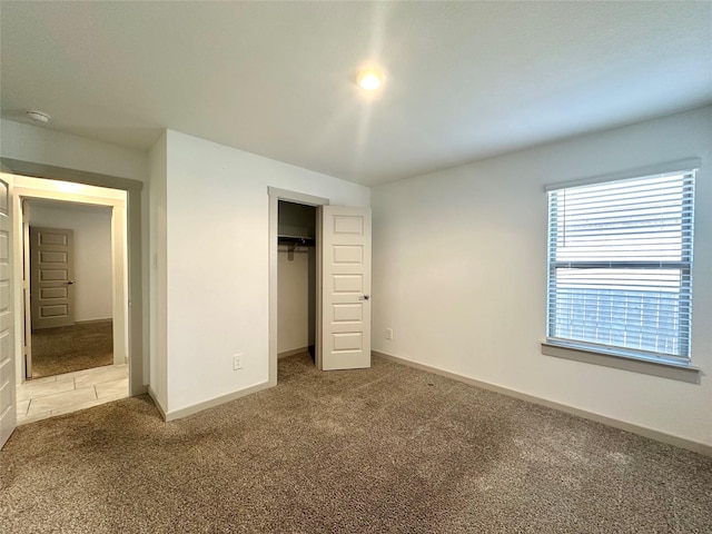 unfurnished bedroom with carpet floors and a closet