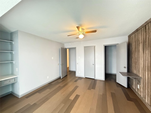 unfurnished bedroom with ceiling fan, hardwood / wood-style floors, and a textured ceiling