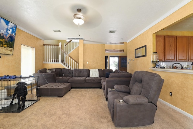 living room featuring crown molding, sink, and light carpet