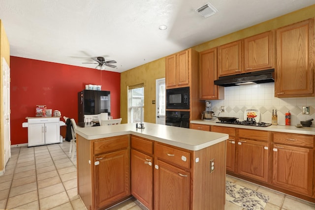 kitchen with a center island, light tile patterned floors, ceiling fan, decorative backsplash, and black appliances