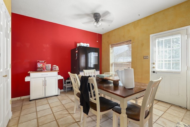 tiled dining area featuring ceiling fan