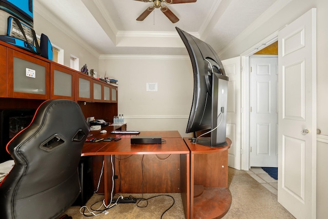 office space with a raised ceiling, ornamental molding, and ceiling fan