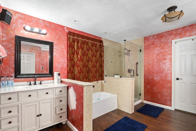 bathroom with hardwood / wood-style flooring, vanity, separate shower and tub, and a textured ceiling