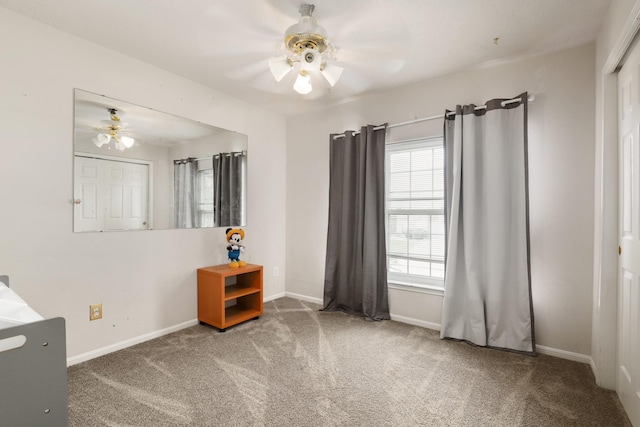 carpeted empty room featuring ceiling fan