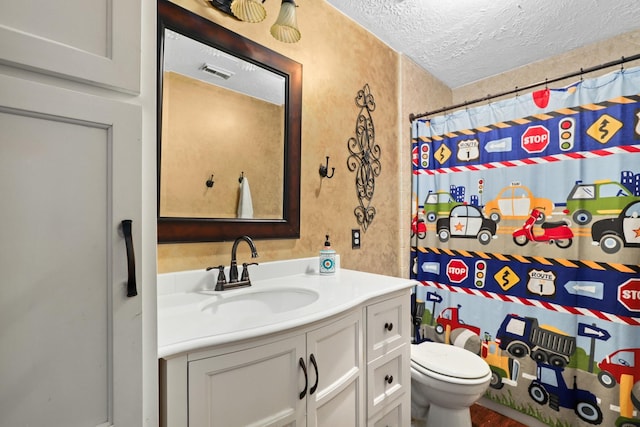 bathroom featuring vanity, curtained shower, a textured ceiling, and toilet