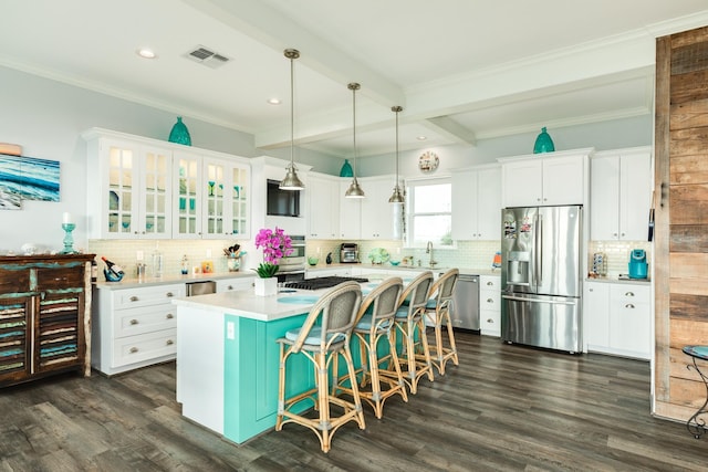 kitchen featuring stainless steel appliances, a center island, a breakfast bar area, and white cabinets