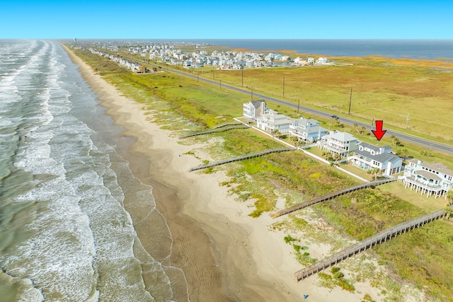 birds eye view of property with a water view and a view of the beach