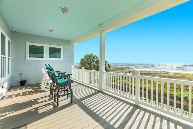 deck with a water view and a beach view